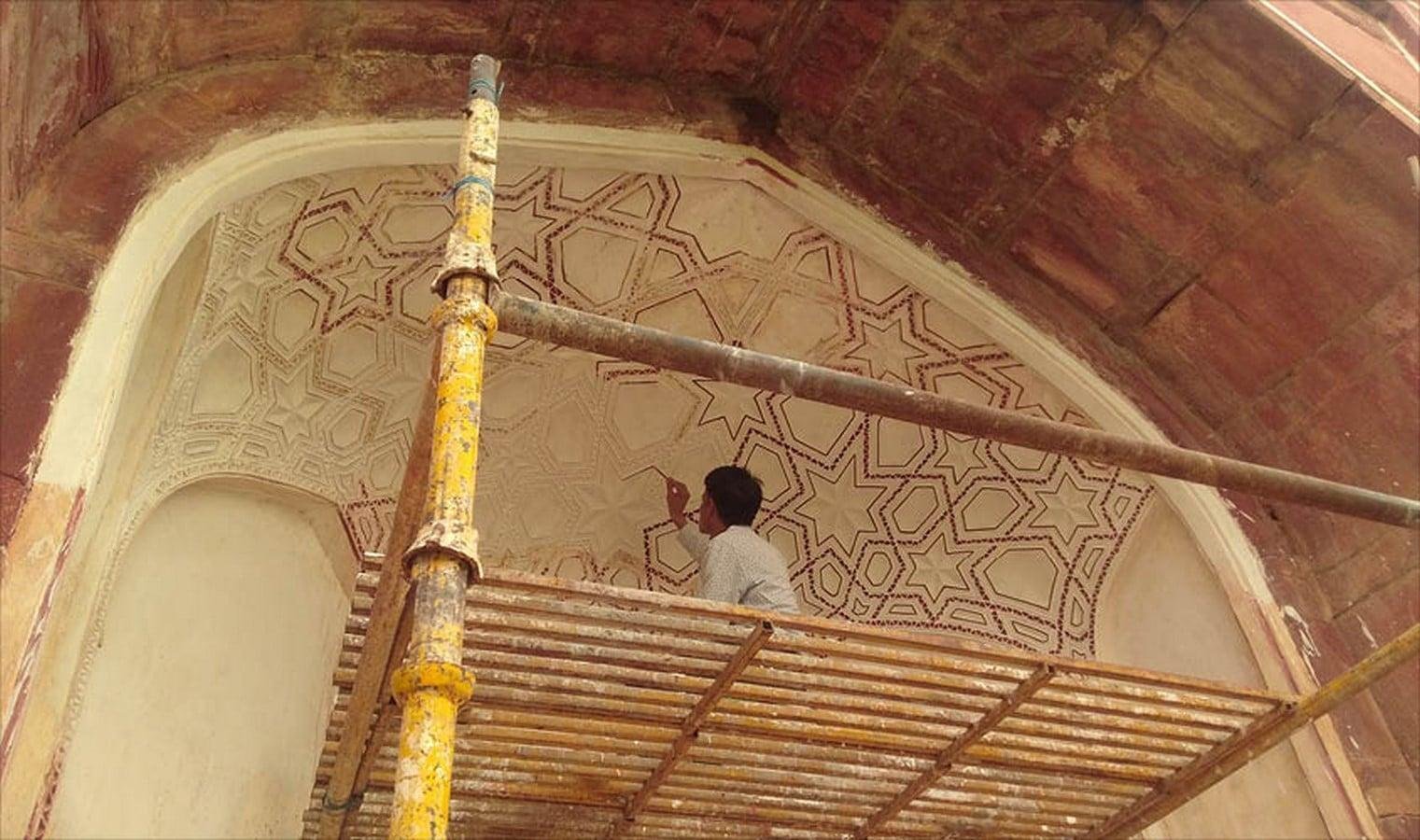 Conservation and restoration work underway at a historic monument in India